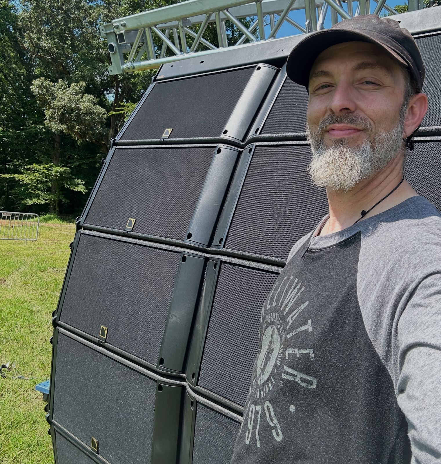Stagebot audio engineer next to a flown line array