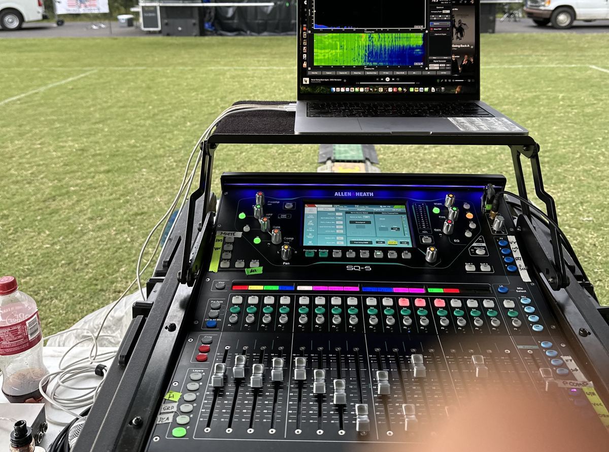 Smaart running on a laptop above an Allen & Heath SQ5 console at front of house