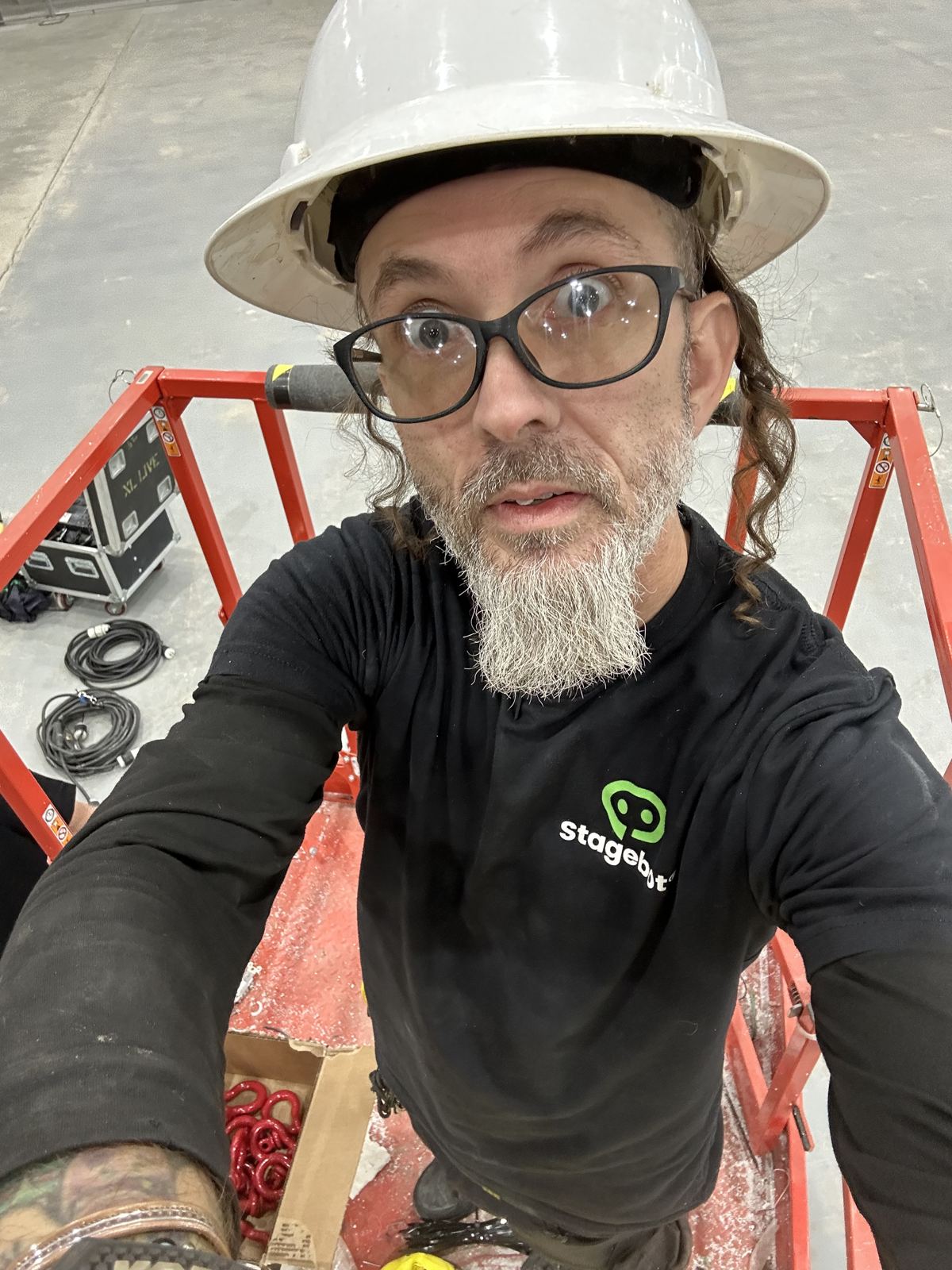 Stagebot production lead in a hard hat and a black Stagebot shirt
